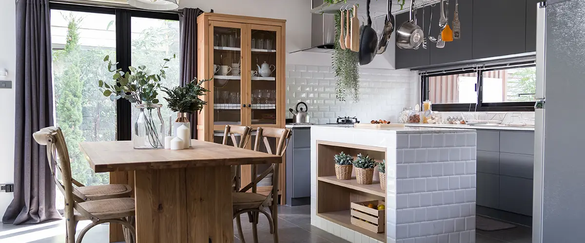 pantry area with natural wood dining table and stainless hanging shelves